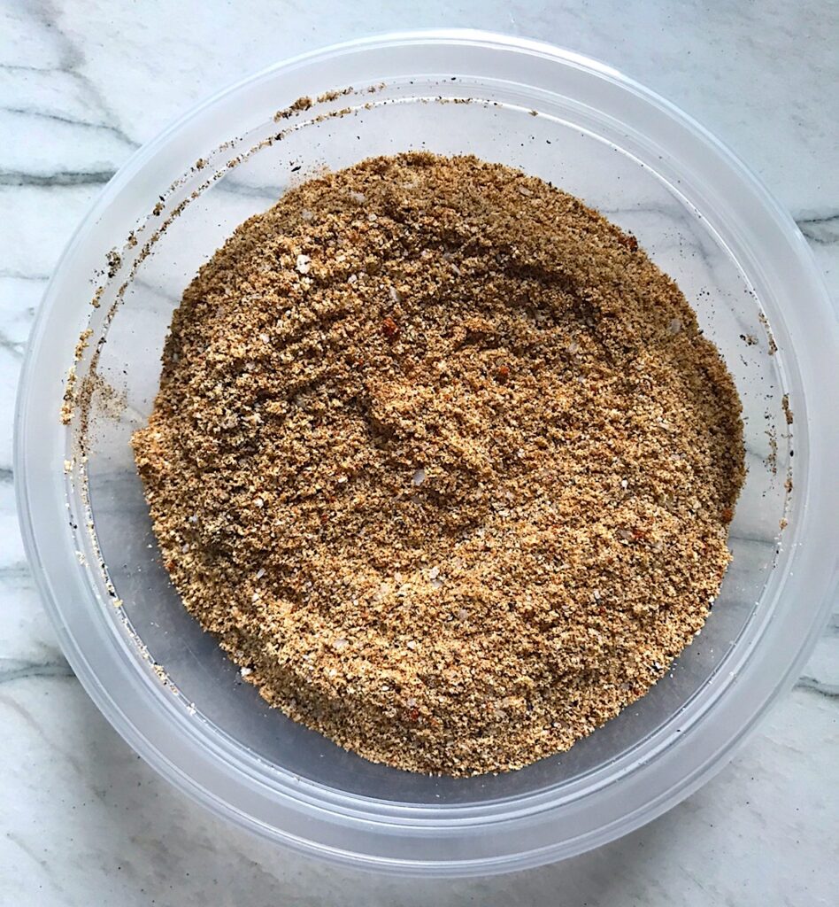 Brazilian Steak Seasoning mixed in a clear bowl on a counter.