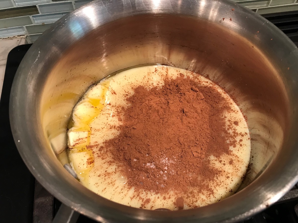 Sweetened condensed milk and chocolate in a pot. This Brigadeiros, Brazilian Chocolate Dessert is based on traditional Brazilian chocolate truffles rolled in sprinkles. You won't believe how easy they are to make!