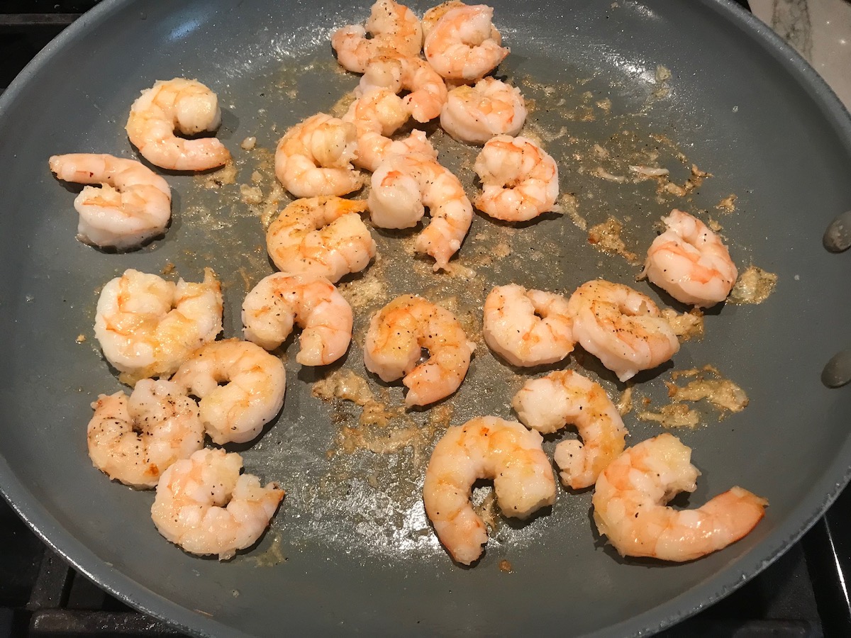 Shrimp cooking in a skillet for Coconut Shrimp Stew Recipe.
