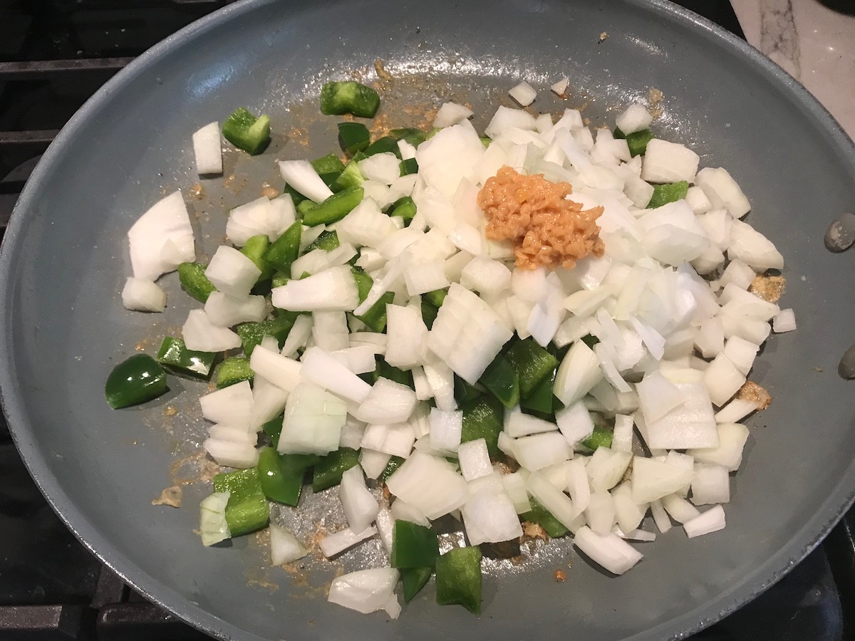 Onions, green pepper, and garlic added to skillet for Coconut Shrimp Stew Recipe.