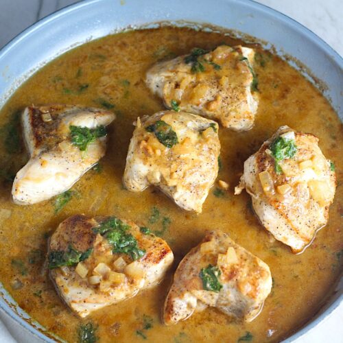 6 pieces of Brazilian Chicken in Peanut Sauce in a pan on counter.