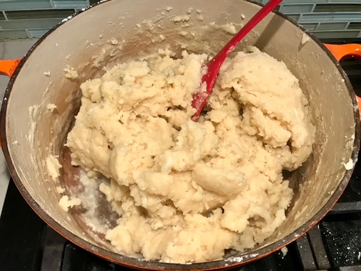 Dough being mixed in pot on stove for Coxinha Chicken Croquettes.
