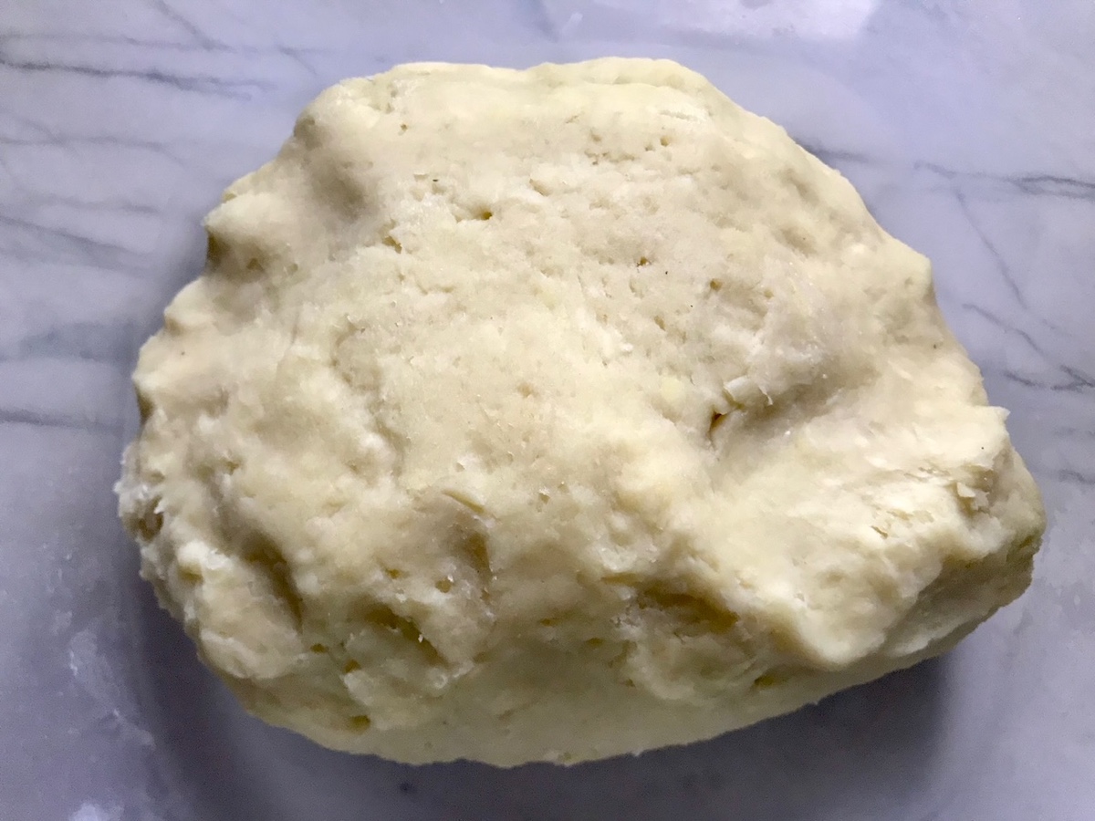 Dough in a ball on counter for Coxinha Chicken Croquettes.