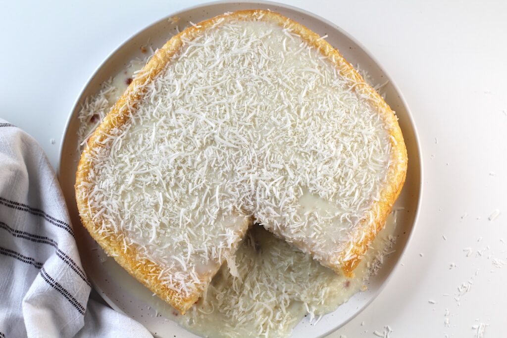 Brazilian Coconut Cake with a piece taken out.