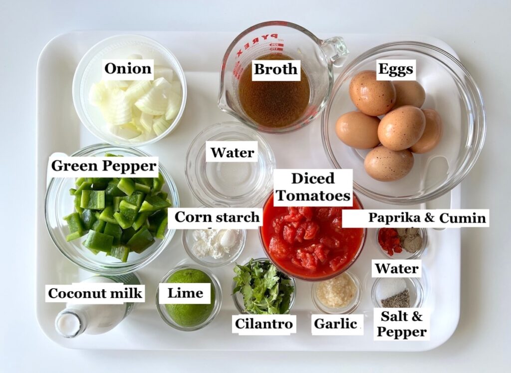 Ingredients chopped, diced, and measured out in bowls and labeled on counter for Moqueca de Ovos.
