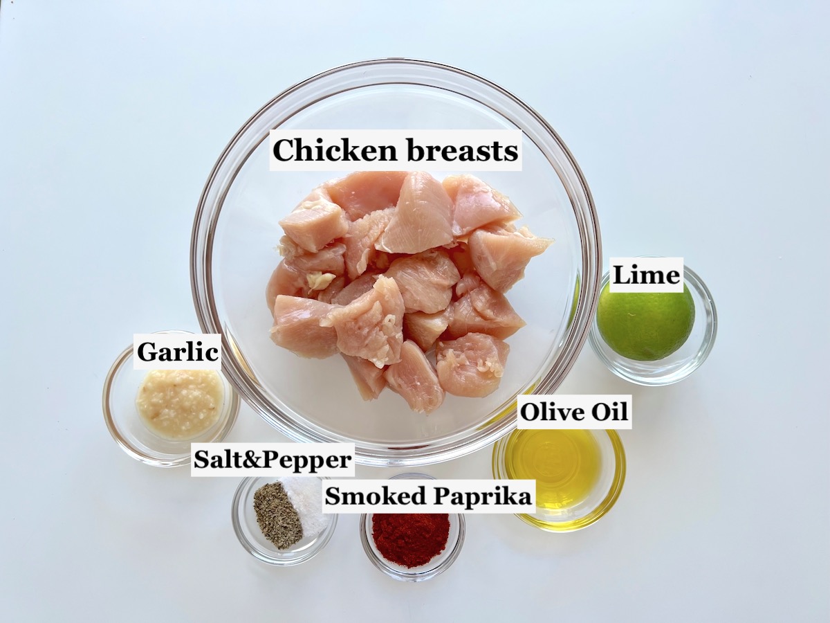 Ingredients prepped and measured out in bowls for the chicken and marinade for Galinhada, Dutch oven chicken and rice.