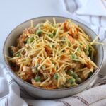 Brazilian Chicken Salad in a bowl with crispy potato sticks on top.