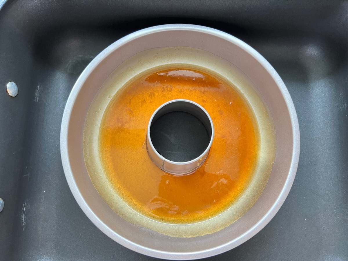Caramel sauce poured into the bottom of the tube pan for Brazilian Flan recipe.