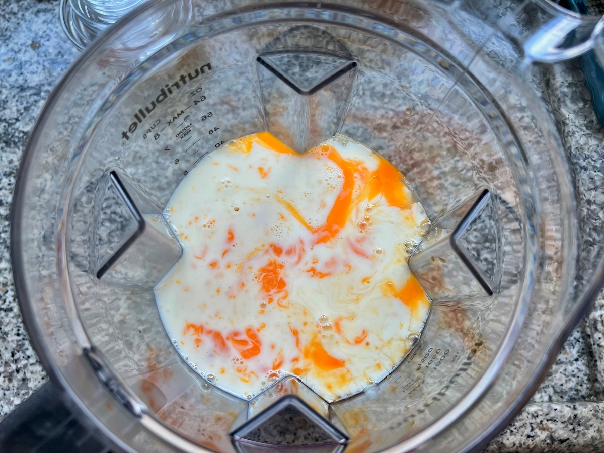 Custard ingredients (eggs, milk, condensed milk) in a blender for Brazilian Flan recipe, or Pudim.
