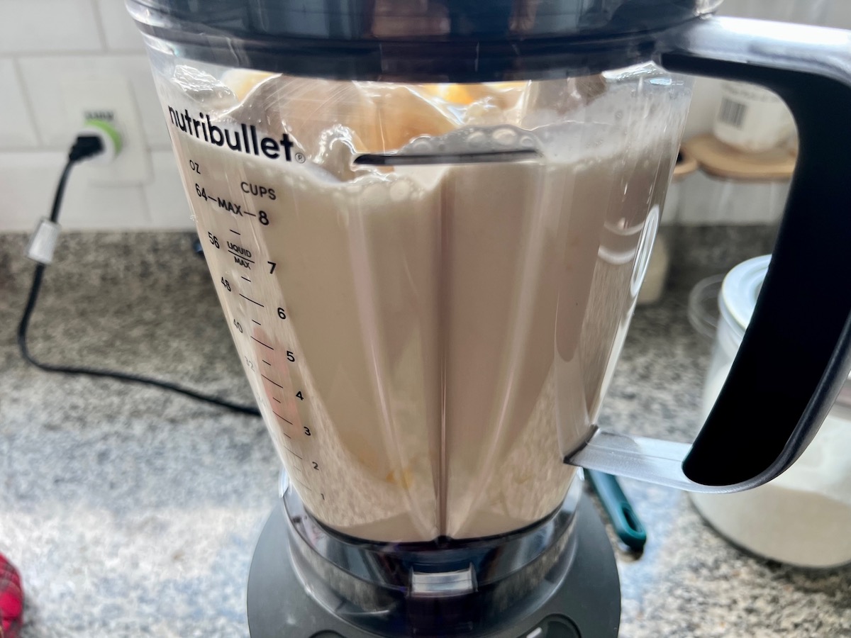 Custard ingredients blending in a blender for Brazilian Flan recipe, or Pudim.