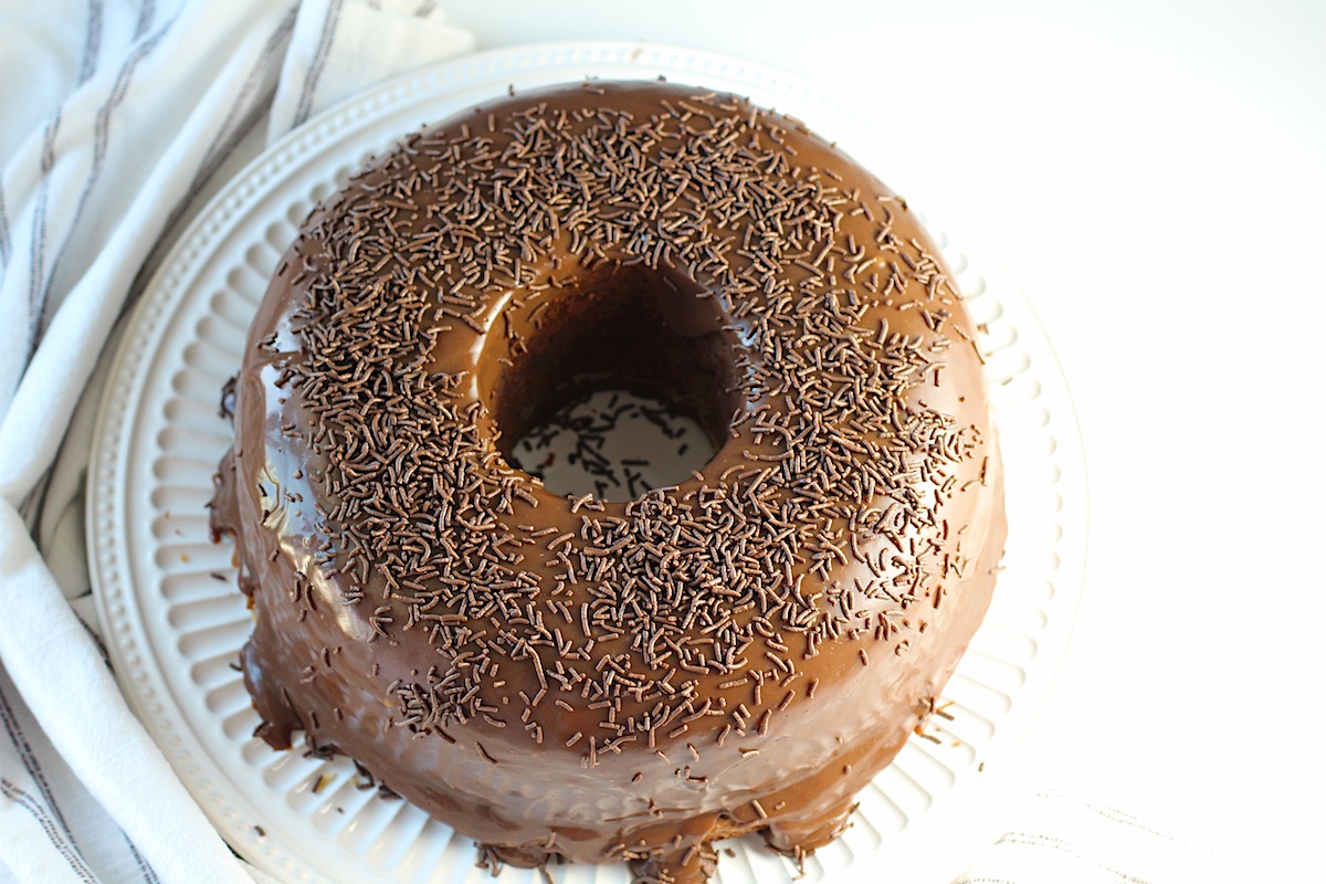 Round Brigadeiro Brazilian Cake with sprinkles on top on a platter.