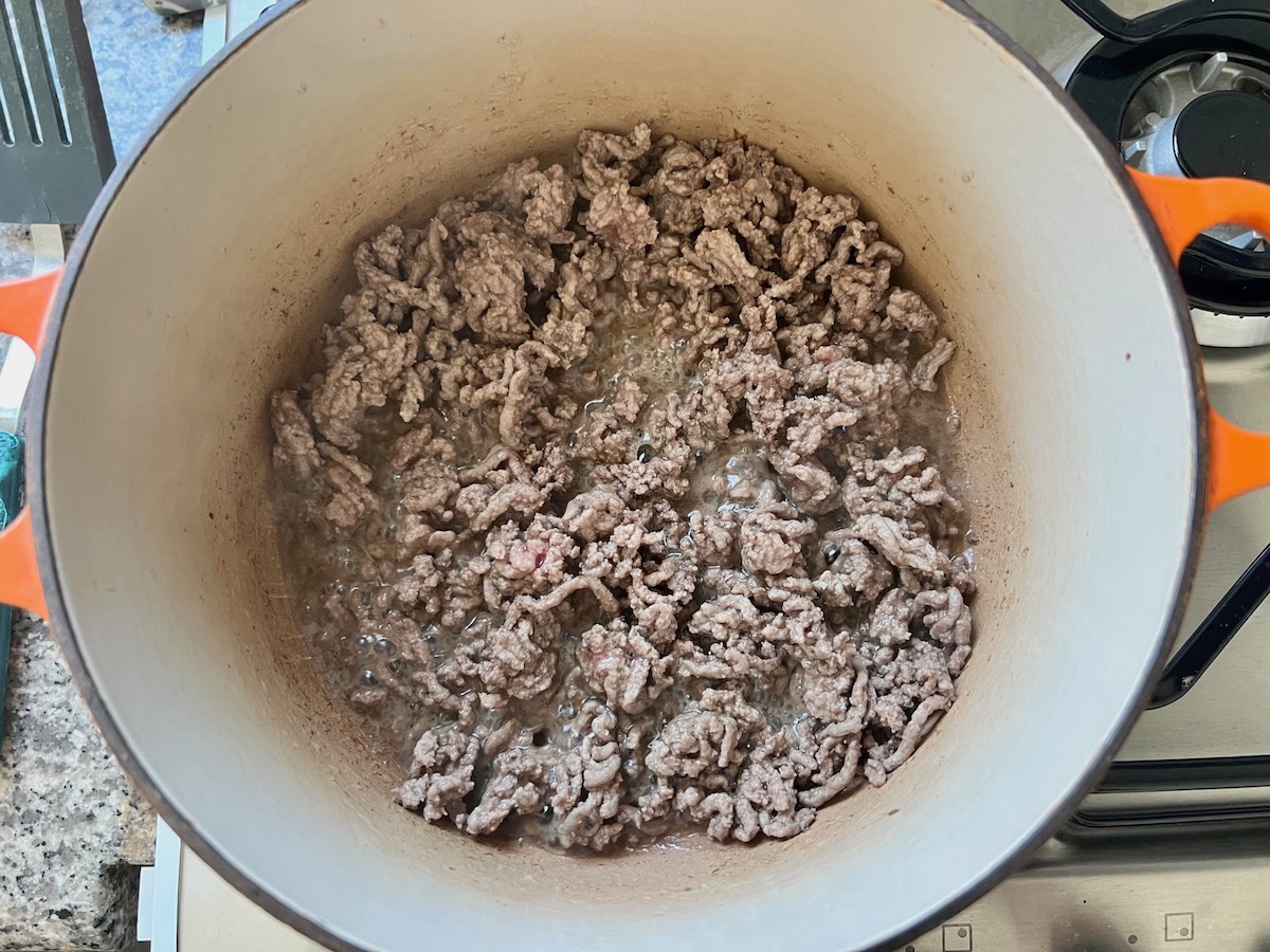 Ground beef cooked in a pot for Summer Beef Stew Picadinho.