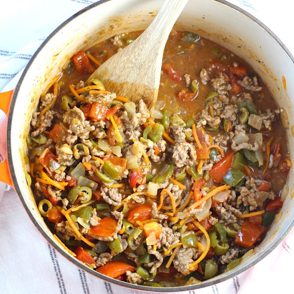 Summer beef stew in a pot with wood spoon. It's based on Brazilian Picadinho.