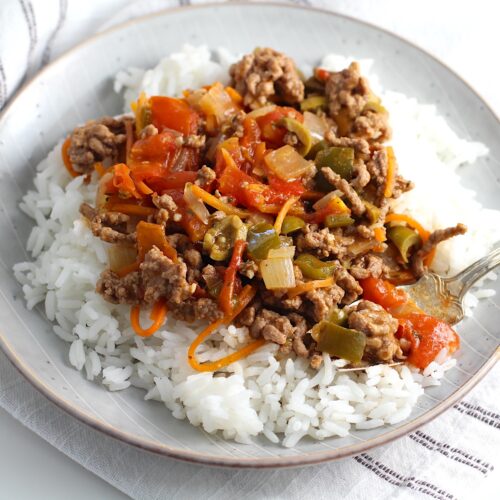 Summer beef stew over rice on a plate. It's based on Brazilian Picadinho.