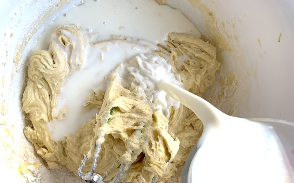 Milk being added to batter alternately with flour for Cake with Lime recipe.