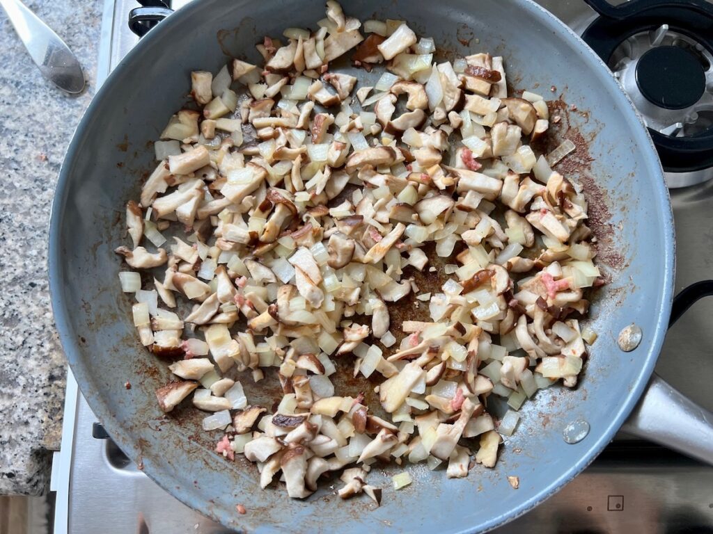 Mushrooms, garlic, and onions added to the pan after sausage was removed for the ragu for Spicy Sausage Pasta.