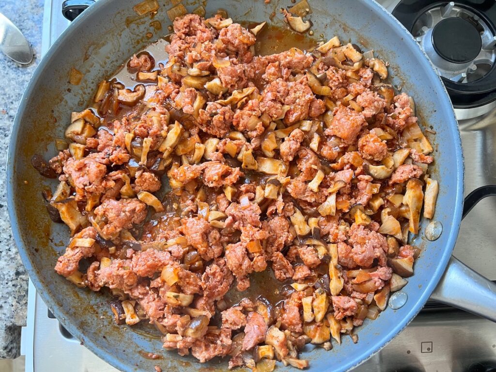 Sausage and Mushroom ragu reduced in a pan for Spicy Sausage Pasta recipe.