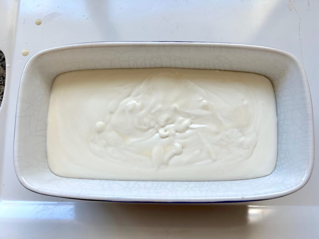 Fully mixed condensed milk and whipped coconut milk cream in a loaf pan ready for freezing for Coconut Ice Cream Recipe without Cream.
