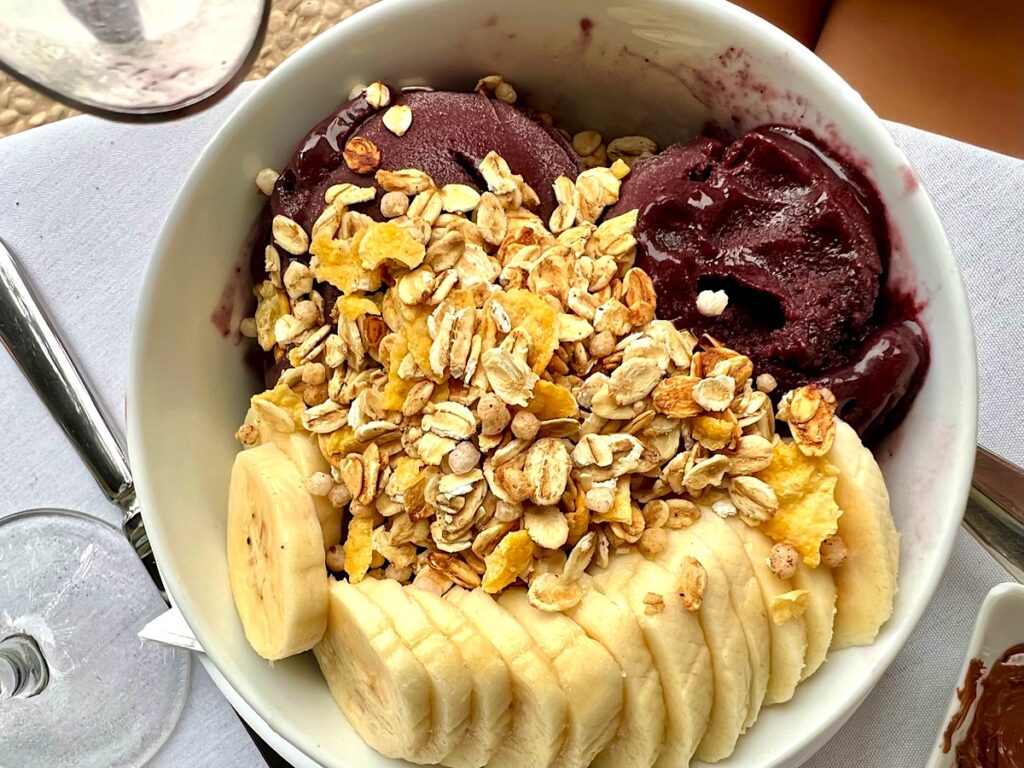 Acai bowl with granola and sliced bananas.