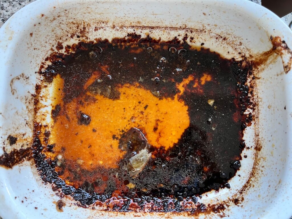 Pan that pork shoulder was roasted in with lots of drippings and browned bits on the bottom.