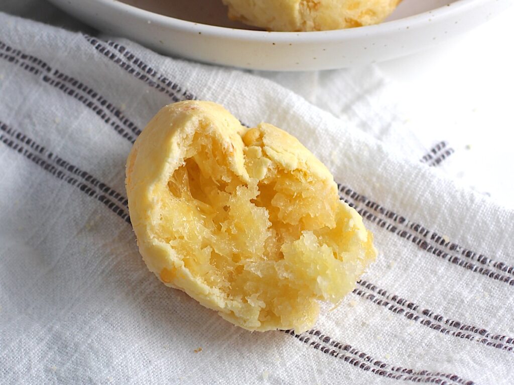 Close up of the inside of cheesy Gluten Free Brazilian Cheese bread, or Pao de Queijo.