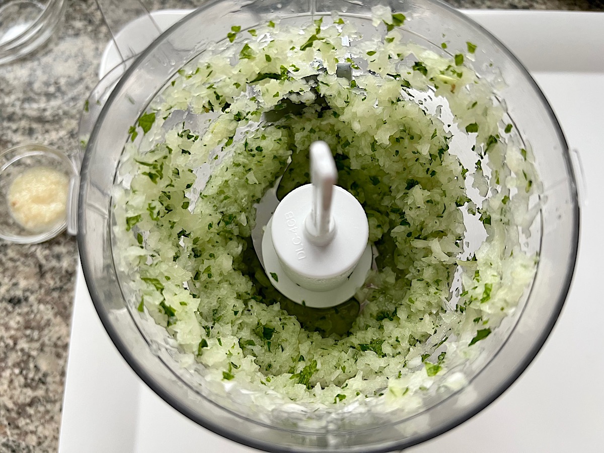 Onion and fresh mint leaves blended in food processor for Kibe Mediterranean Ground Beef Kabab recipe.