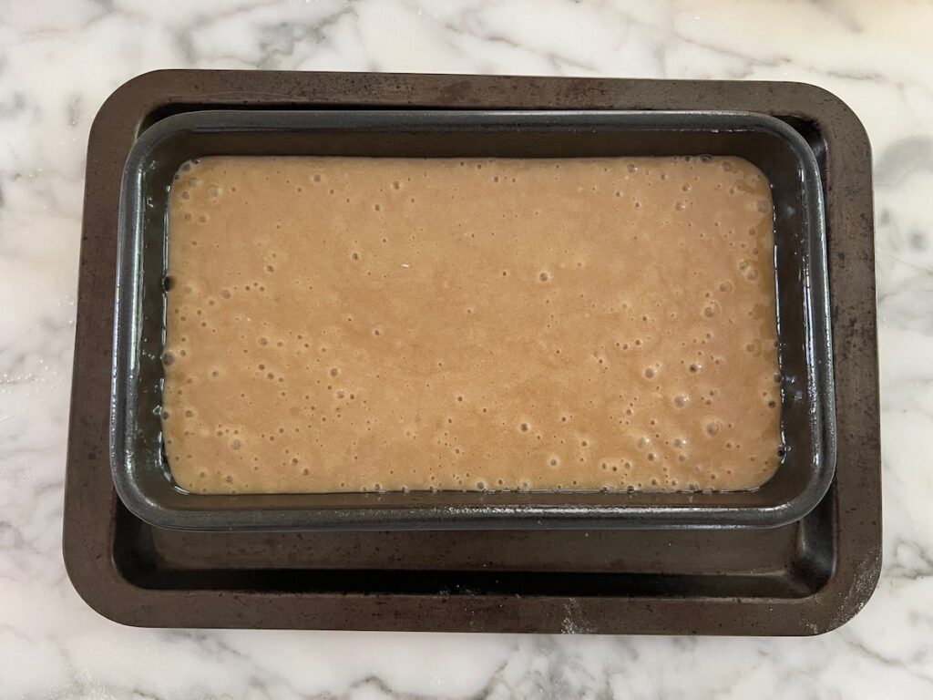 Batter poured into the loaf pan before baking for the Honey Loaf recipe.