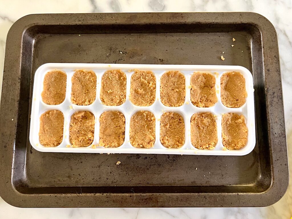 Brazilian Peanut Candy (Pacoca) pressed into an ice cube tray or mold.
