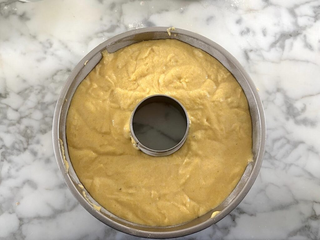 Batter poured into bundt pan before baking for this Bolo de Fuba, Cornmeal Cake, recipe.