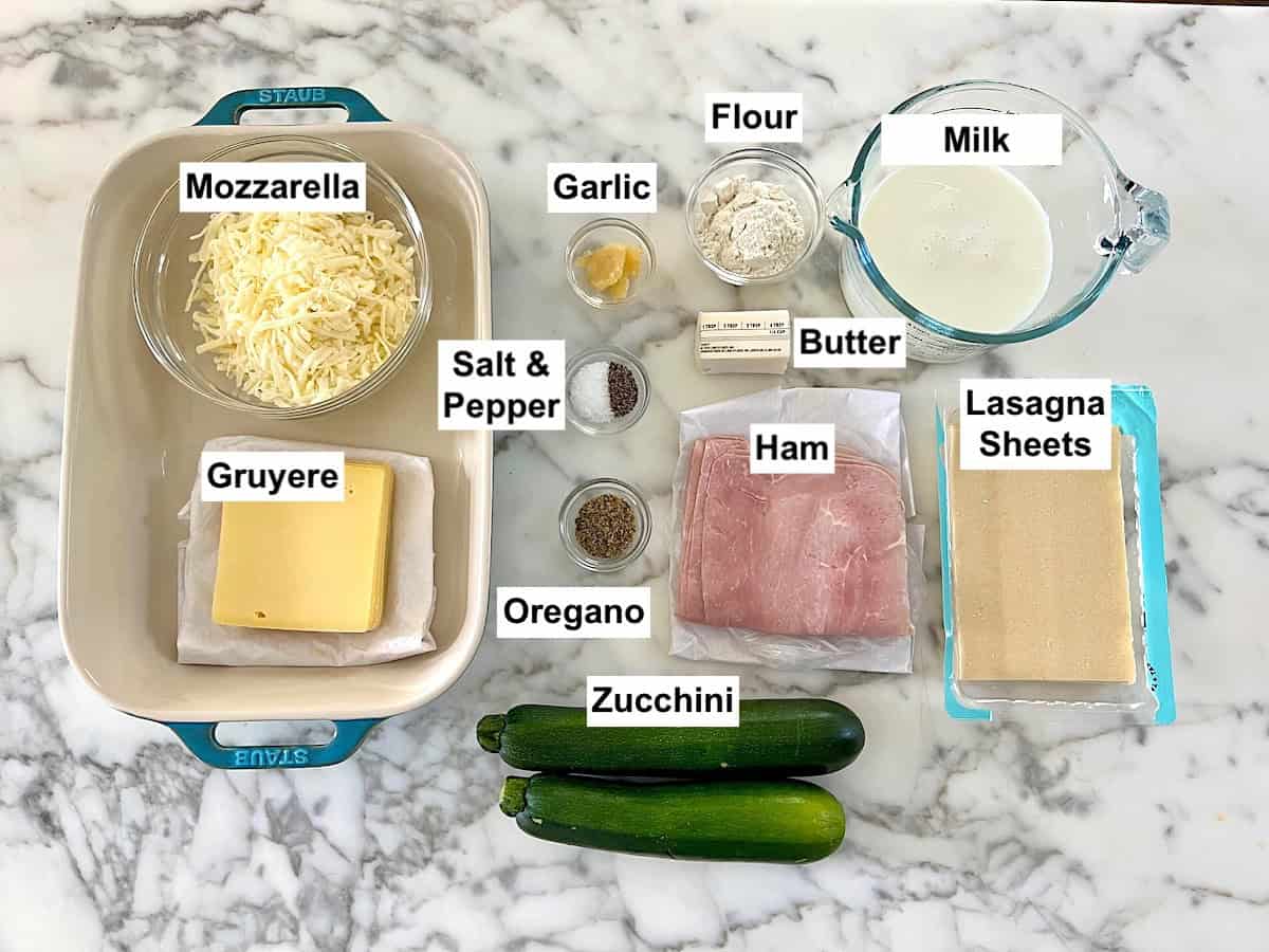 All ingredients measure out in bowls on counter and labeled for this Bechamel Sauce Lasagna recipe.