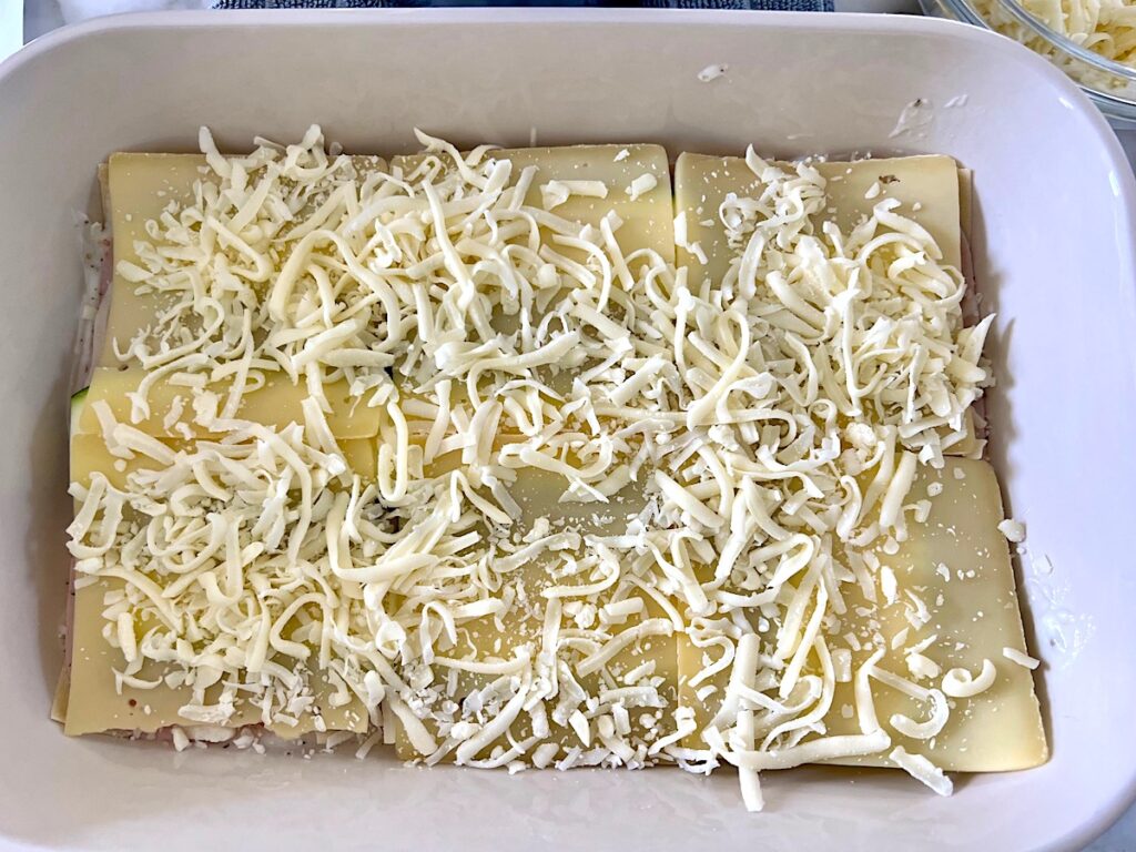 Cheese layered onto the Bechamel Sauce Lasagna recipe.